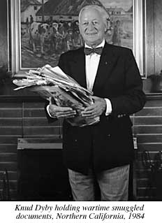 Photograph of Knud Dyby holding smuggled wartime documents, Northern California, 1984